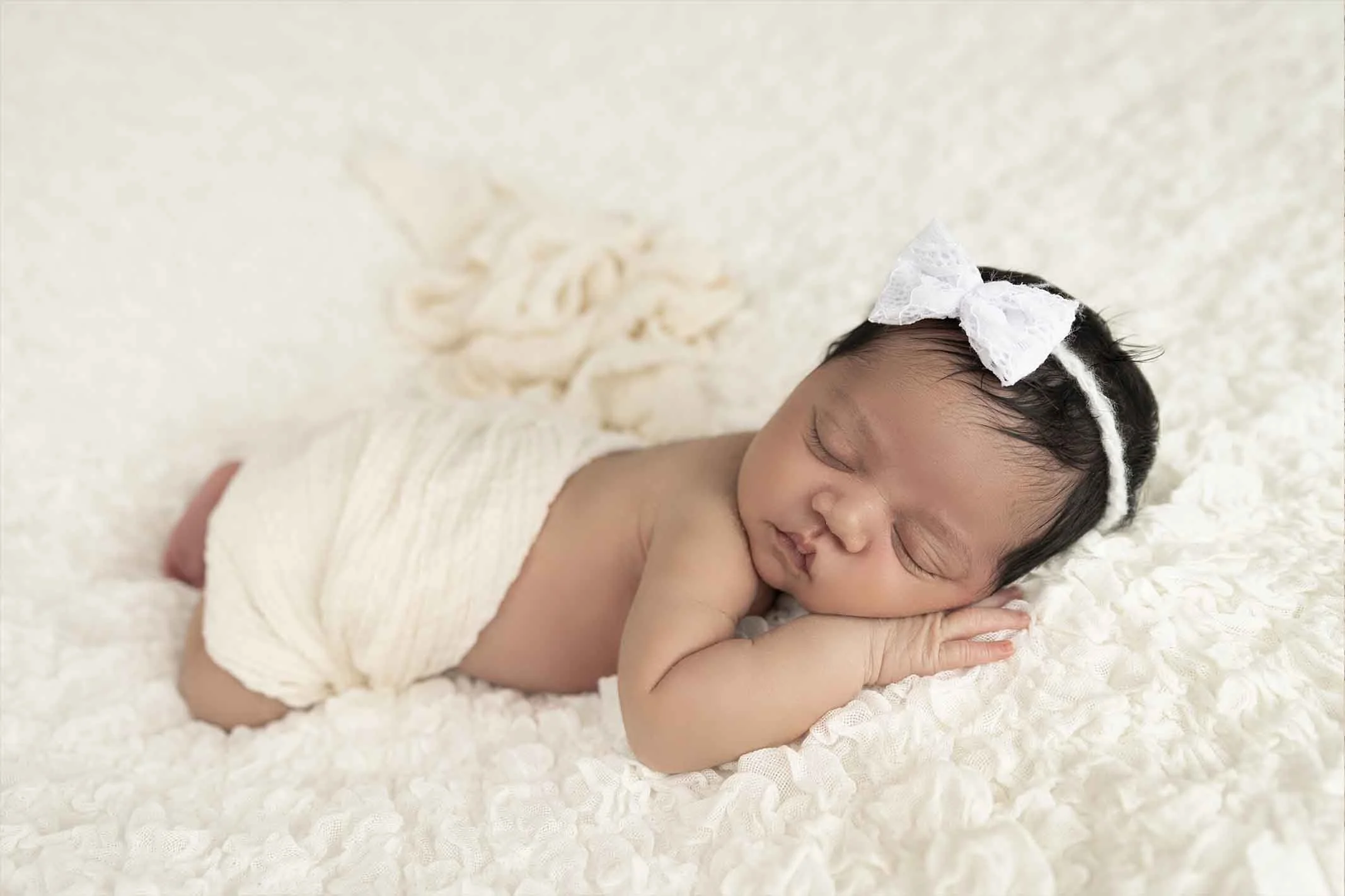 Newborn photos with mobile photographer on sleeping belly