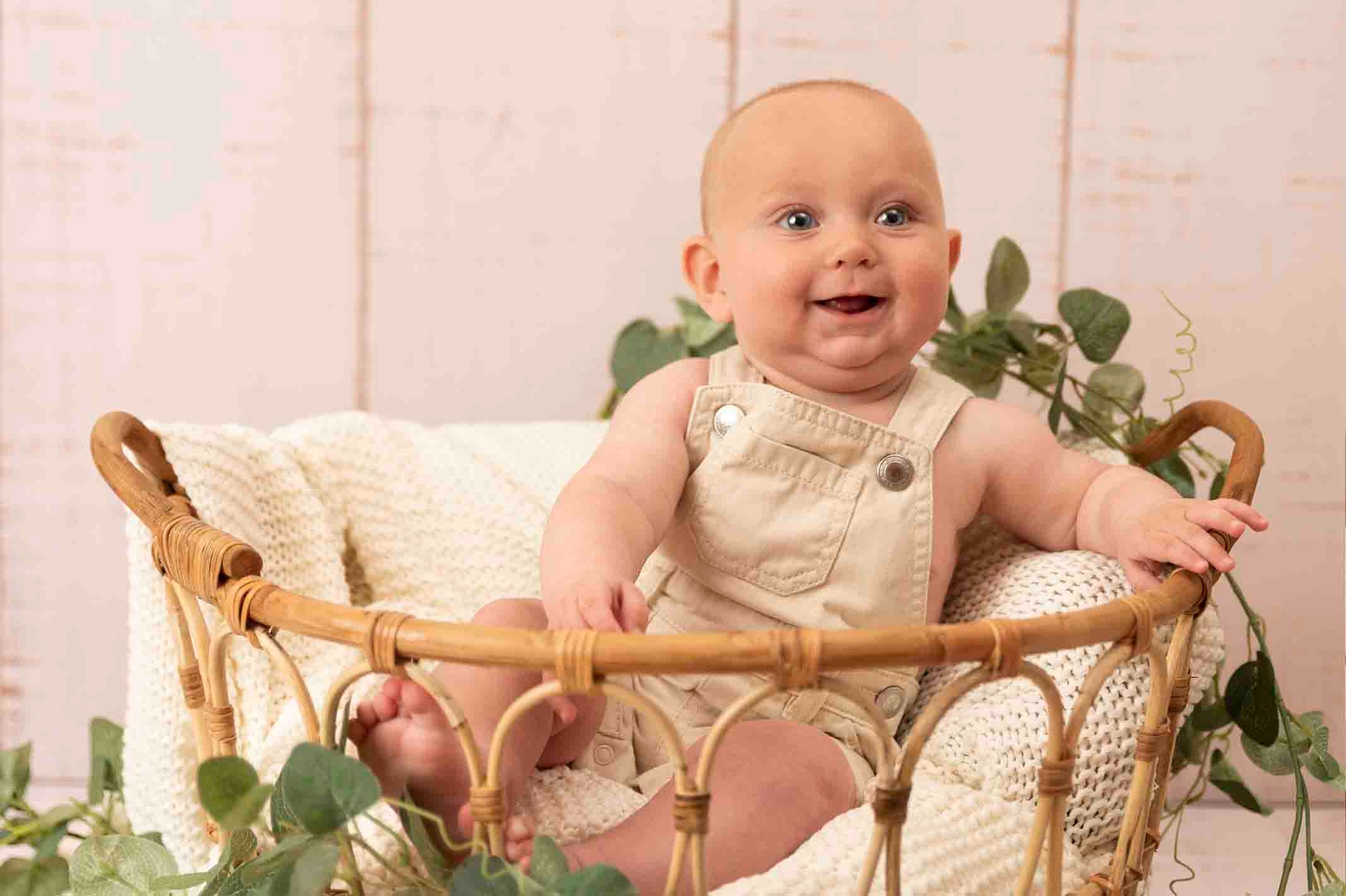 baby boy smiling at baby photoshoot