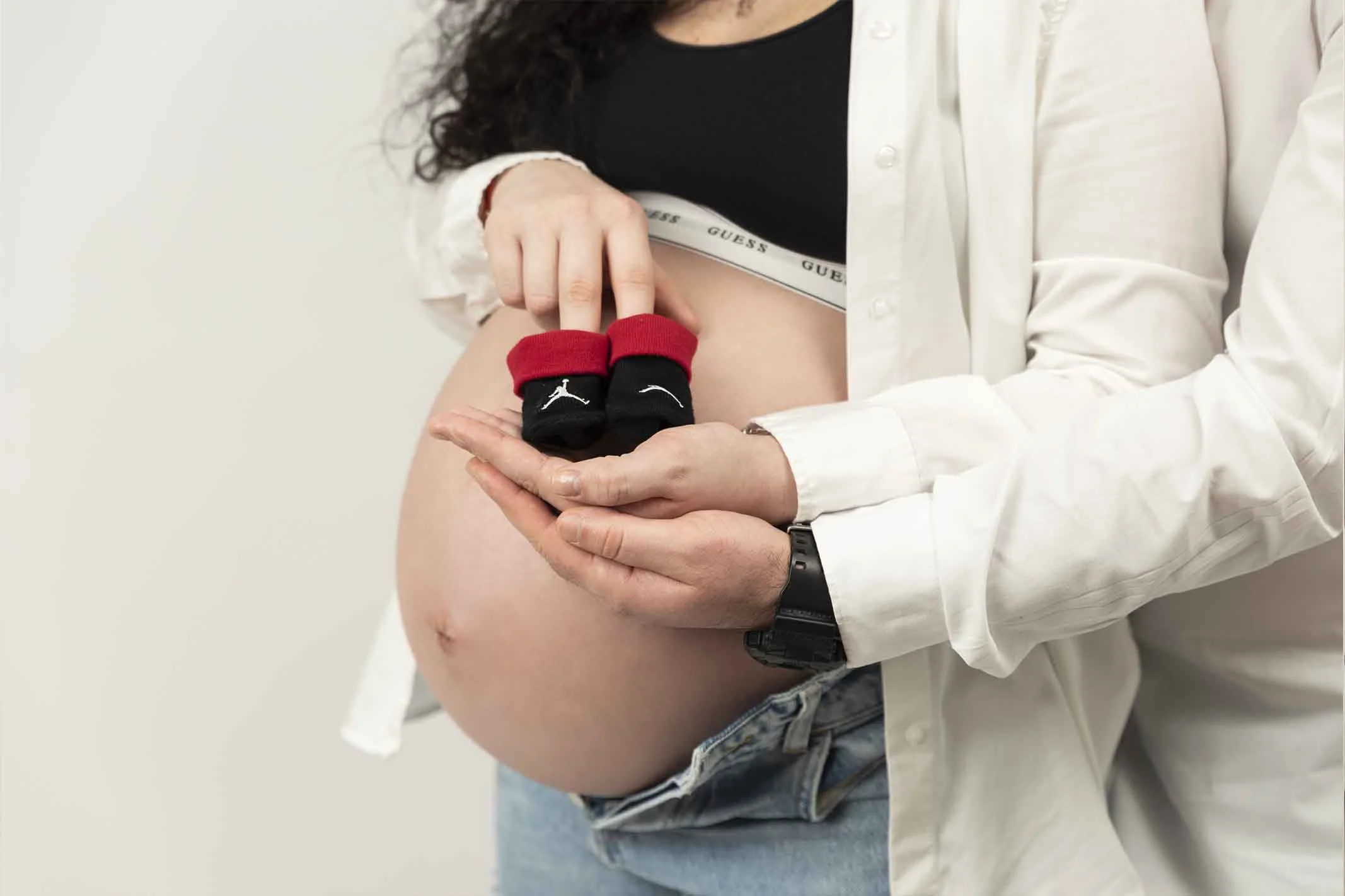 baby bump with small shoes for photoshoot
