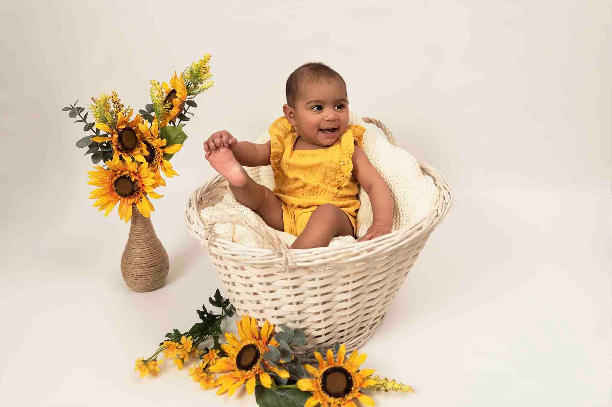 baby dressed in yellow for baby photoshoot