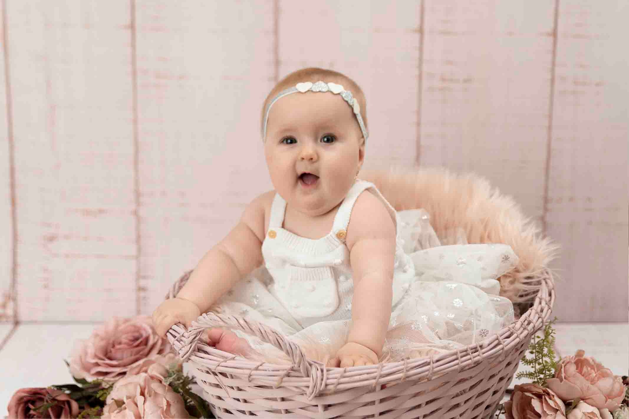 baby girl having fun at baby photoshoot