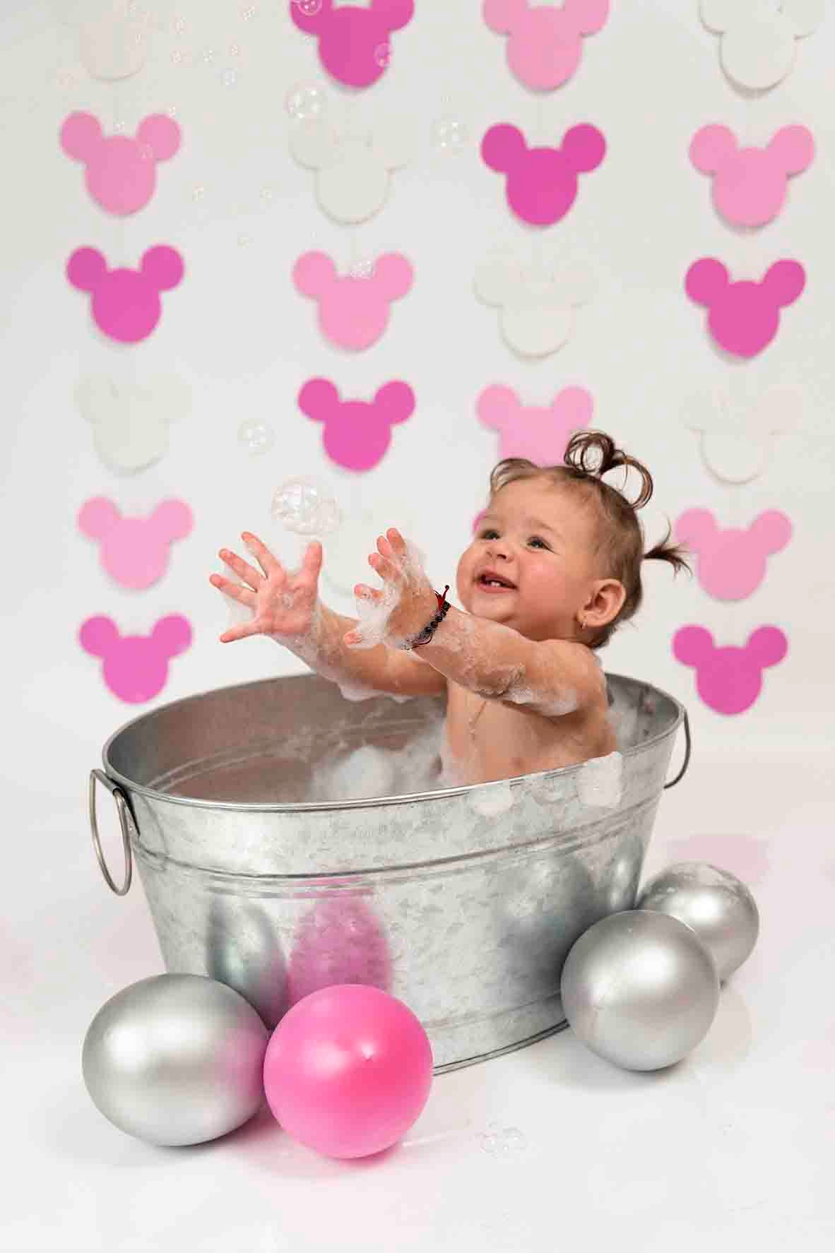 baby girl in cake smash mickey mouse theme