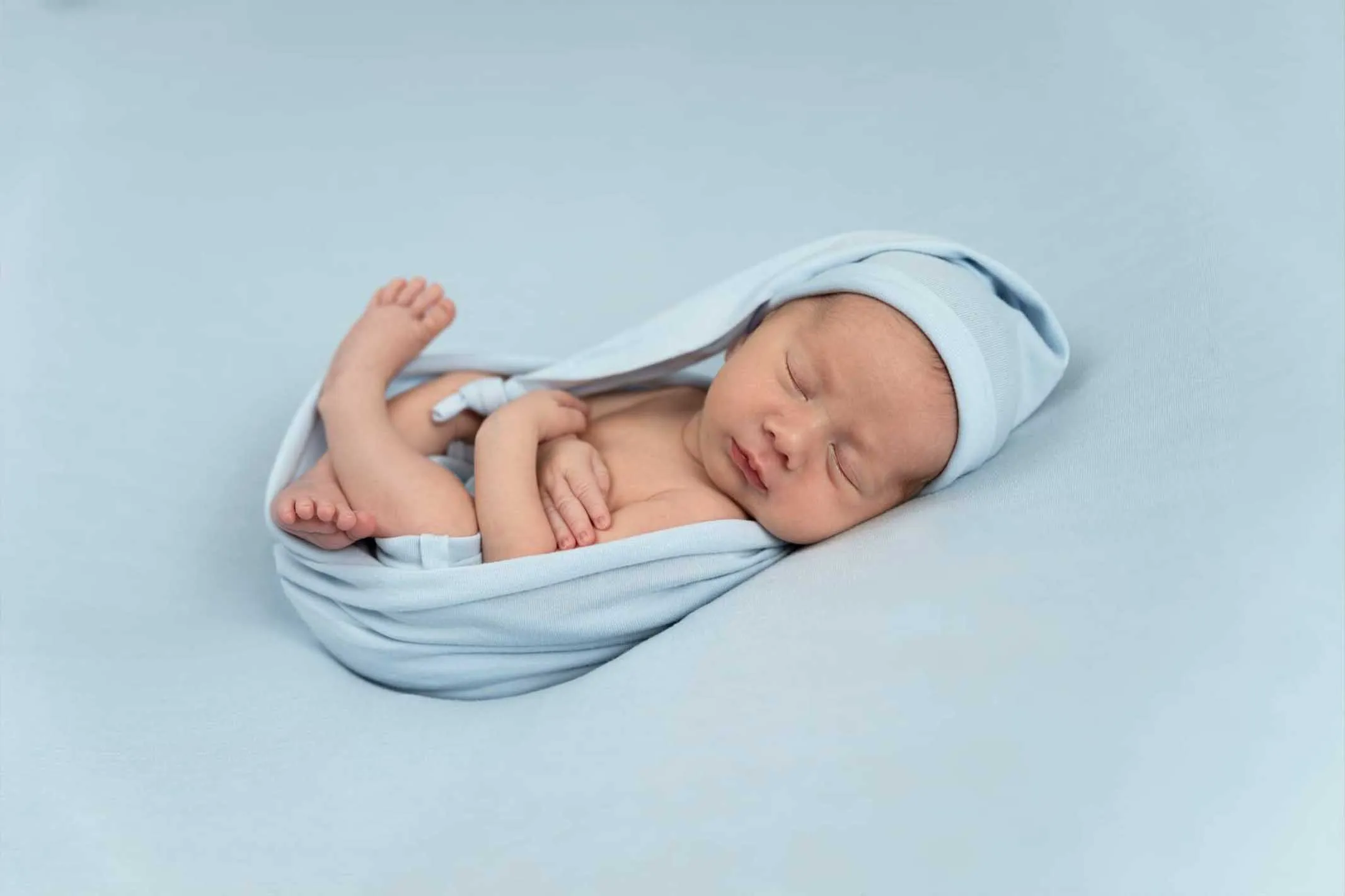 newborn baby in gray heart shape