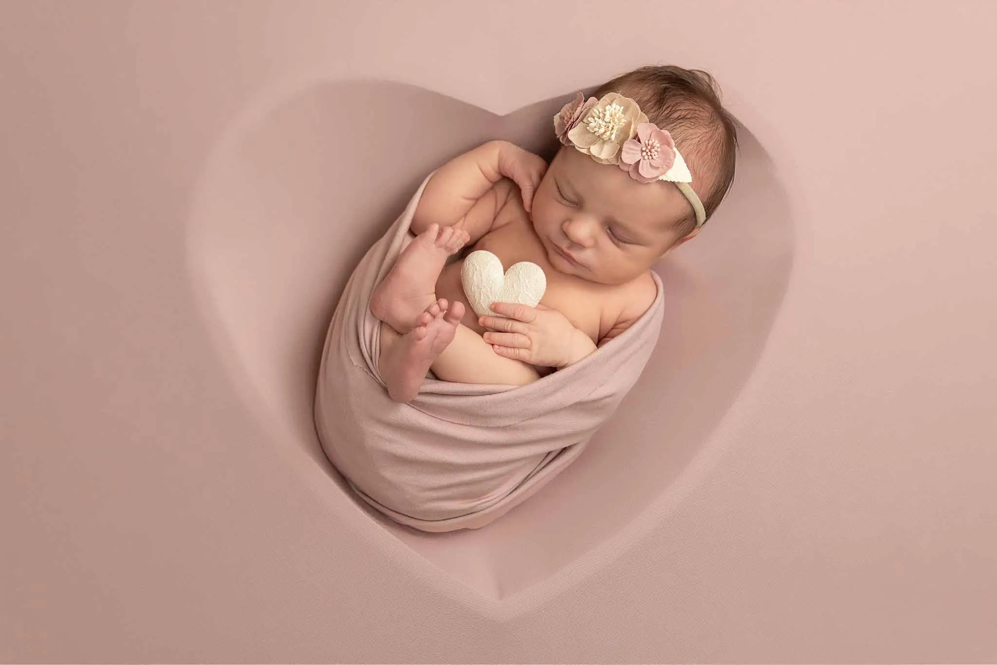 newborn baby girl in heart shape