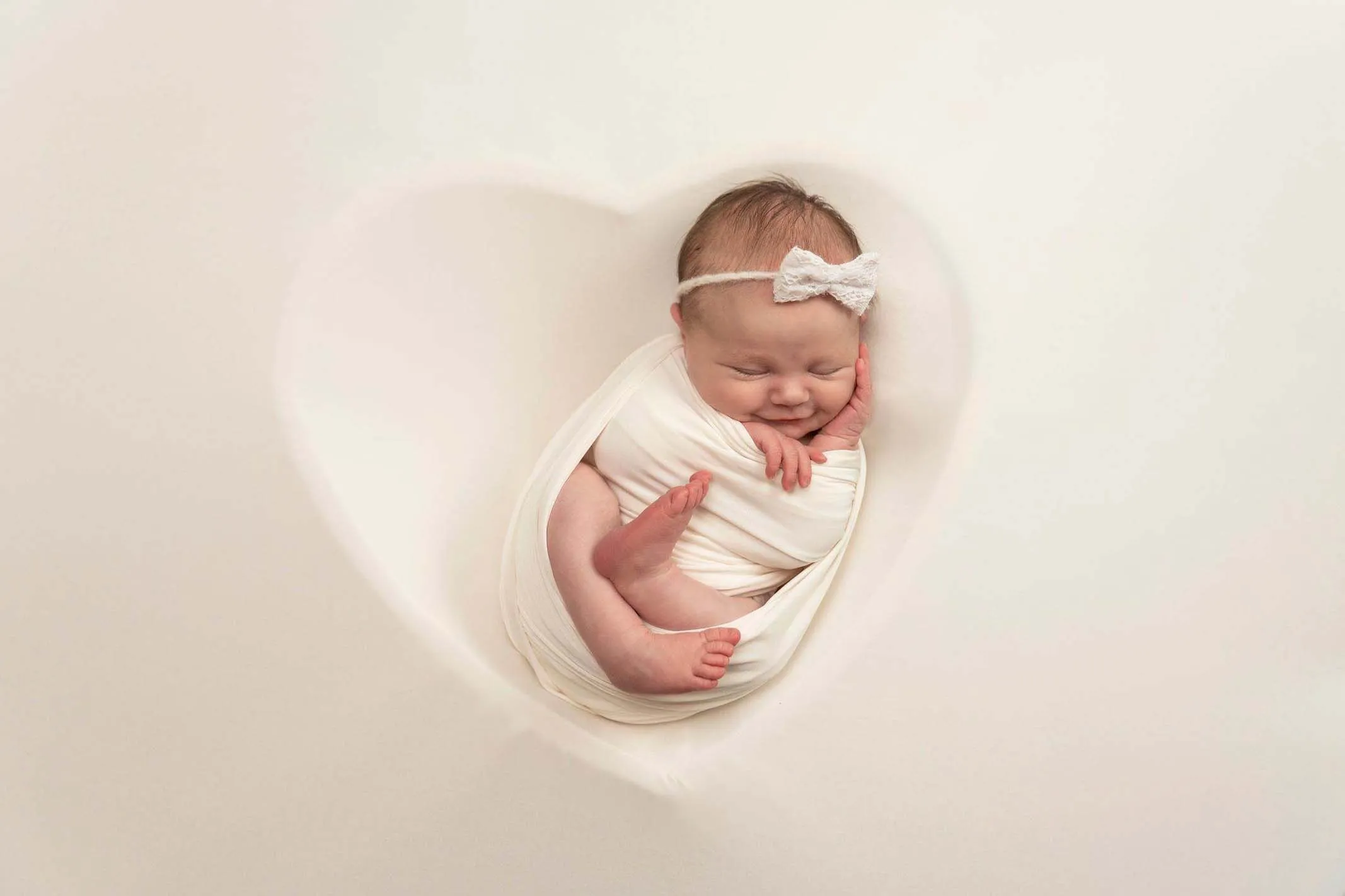 newborn baby girl in heart shape