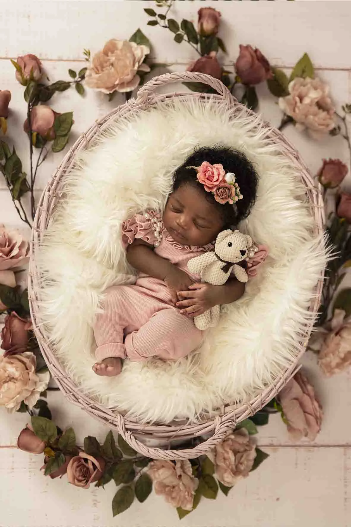 newborn in basket for photoshoot