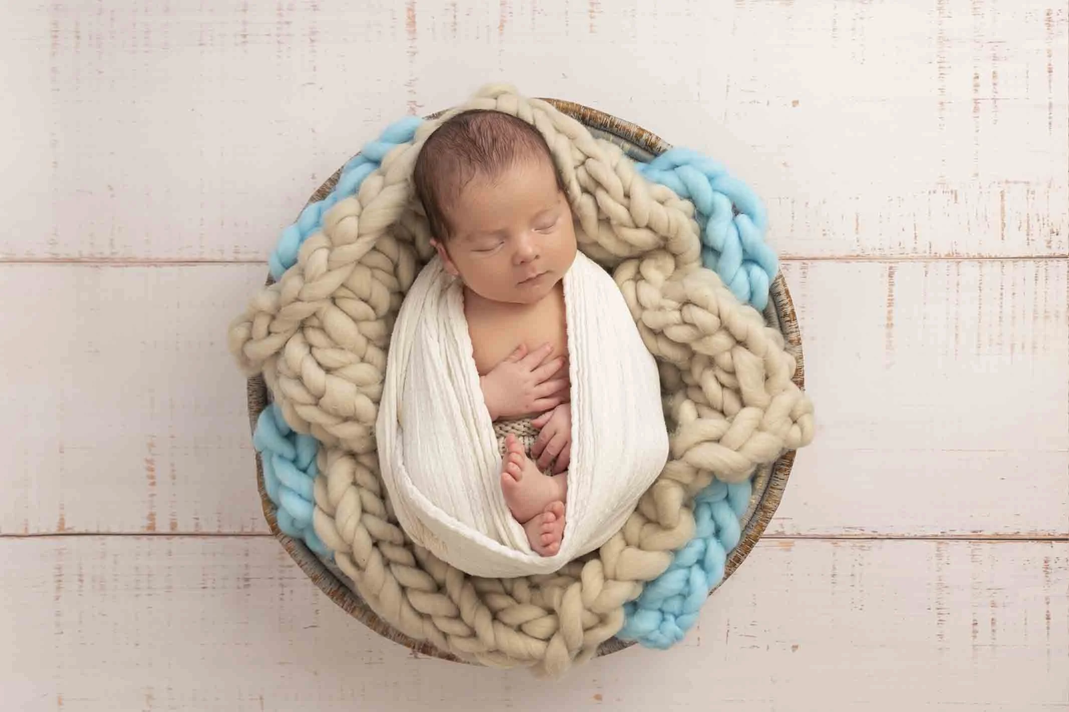 newborn in blue bowl