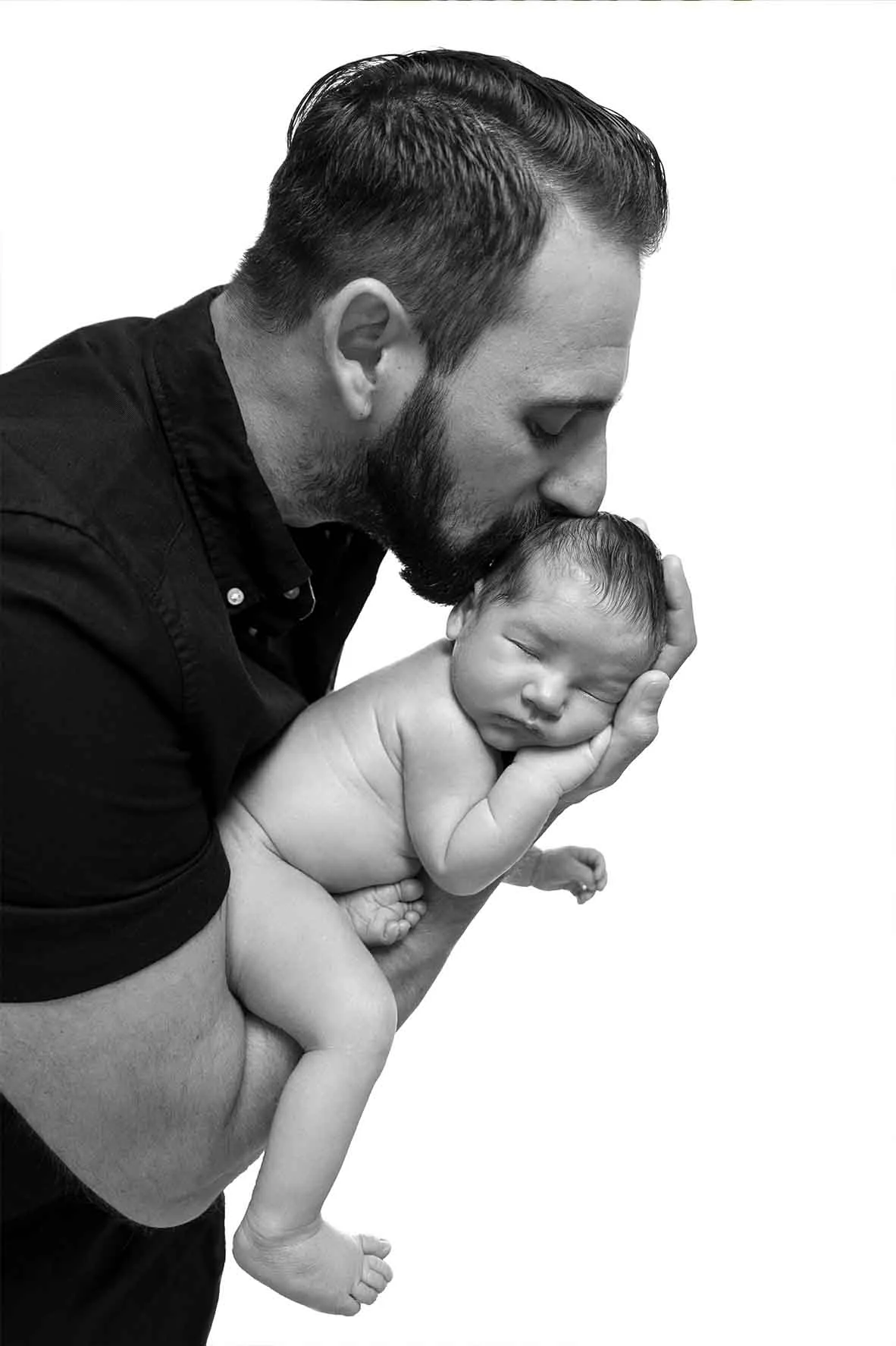 newborn in fathers arm
