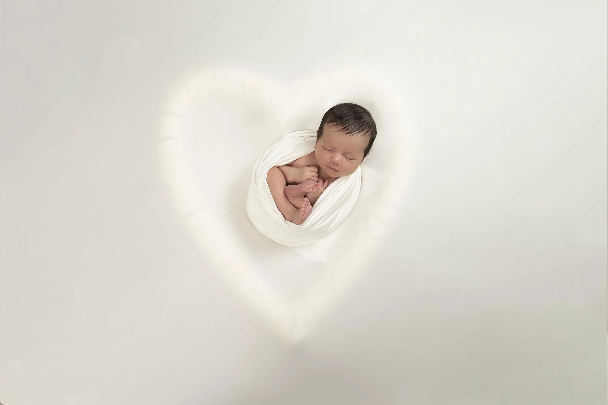 newborn in heart shape