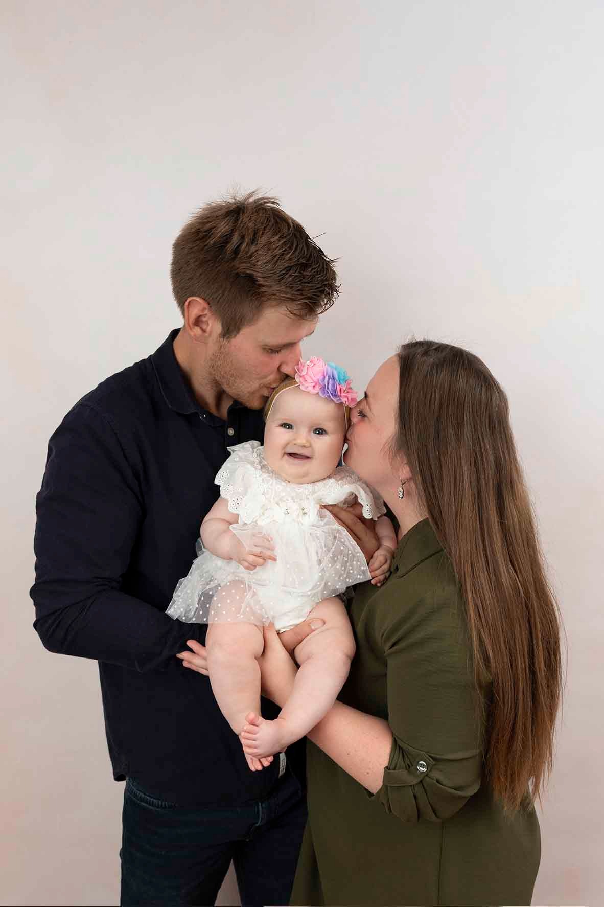parents holding baby at photoshoot